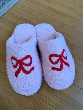 Staykation Cozy Pink Fuzzy Slippers with Red Bow Design